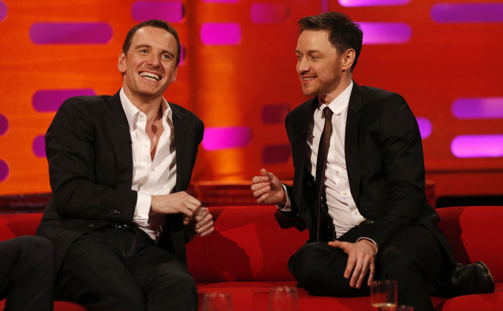 Michael and James sitting and smiling together on a talk show