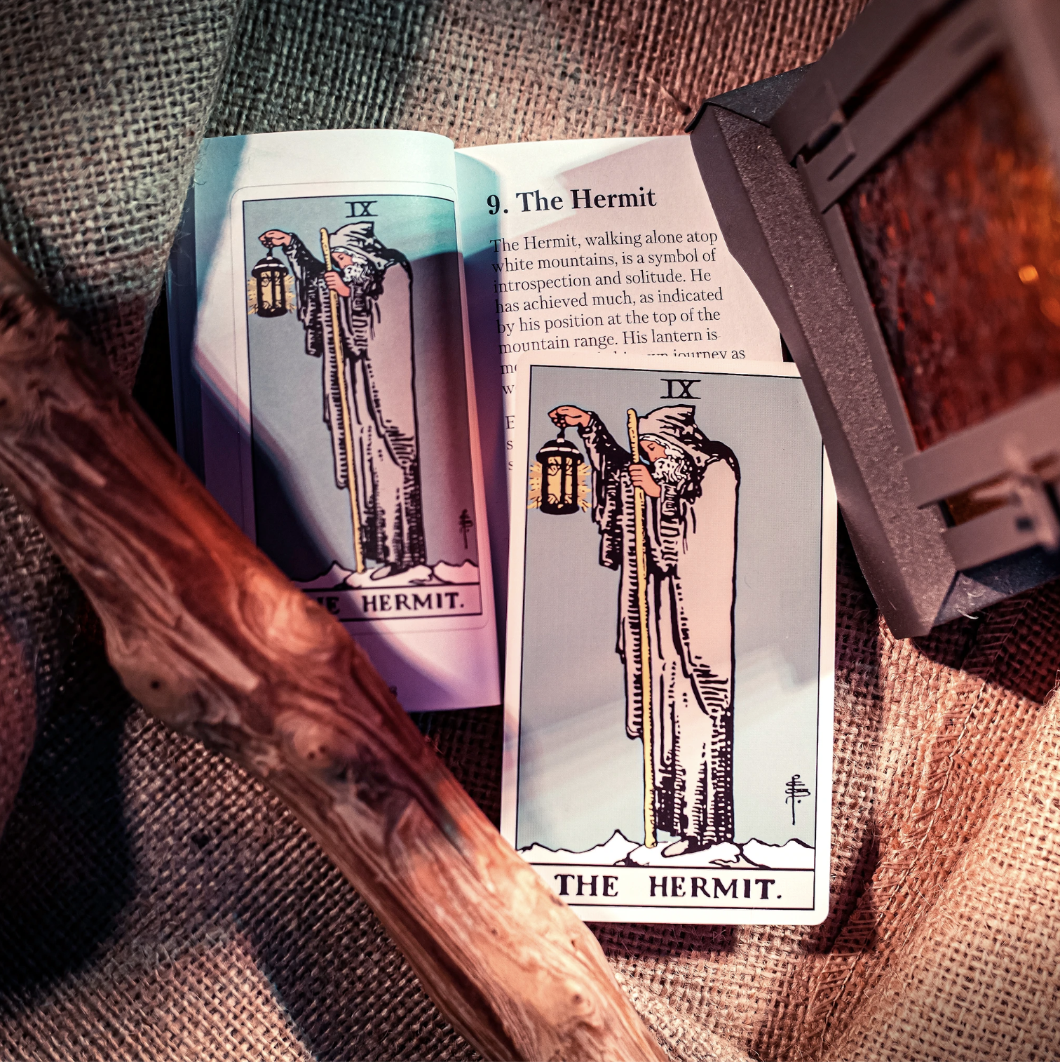 The Hermit card laid out on the tarot guidebook