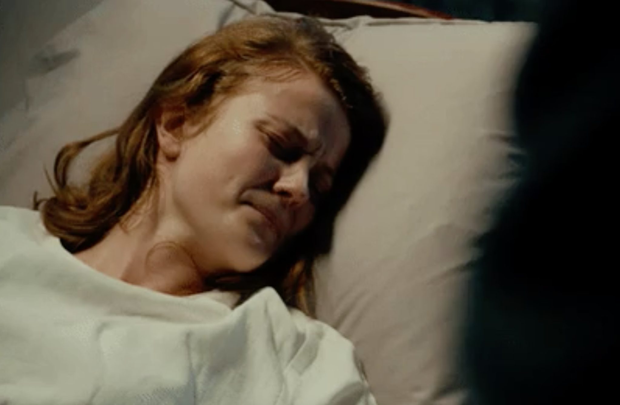 a woman crying in a hospital bed