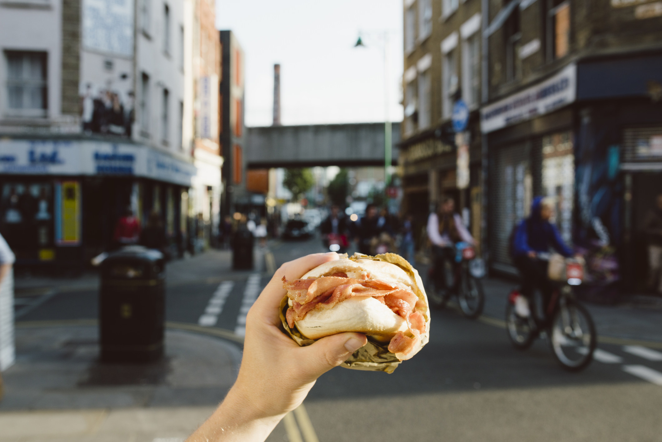 Someone holding street food in a London neighborhood.