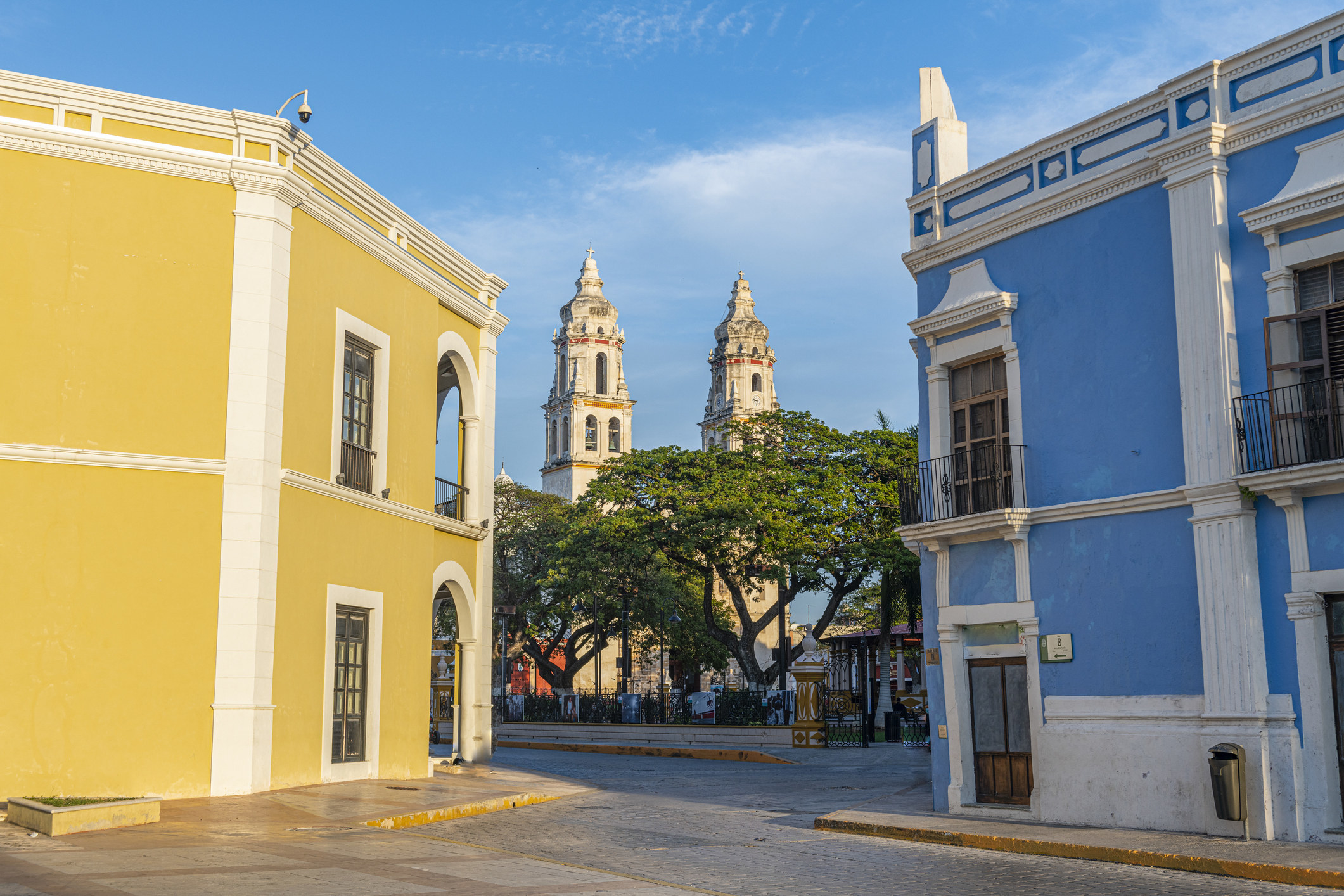 Colorful colonial houses and a cathedral.