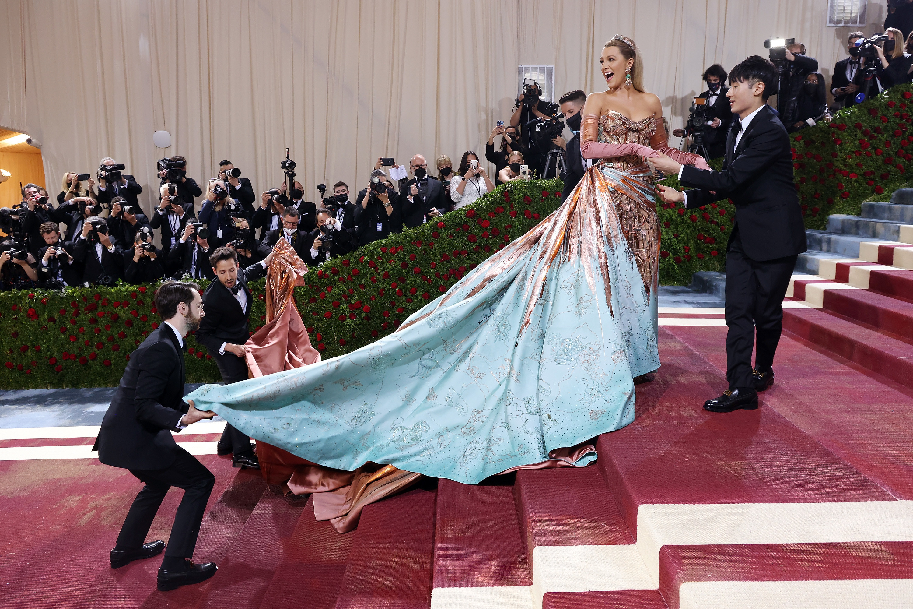 Her dress is unfurled to reveal more detail in the train