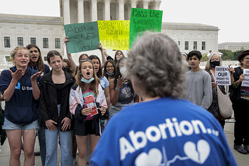 Abortion rights activists yell at an anti-abortion demonstrator