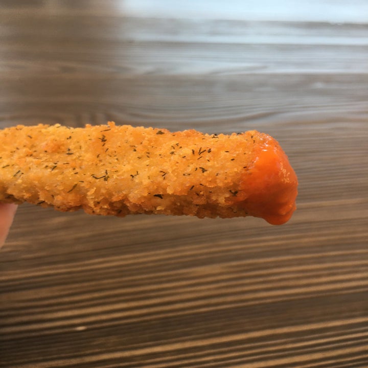 A fried pickle dipped in Truff hot sauce