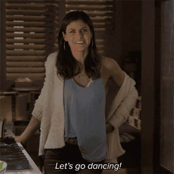 GIF of Alexandra Daddario from Why Women Kill saying, &quot;let&#x27;s go dancing!&quot;