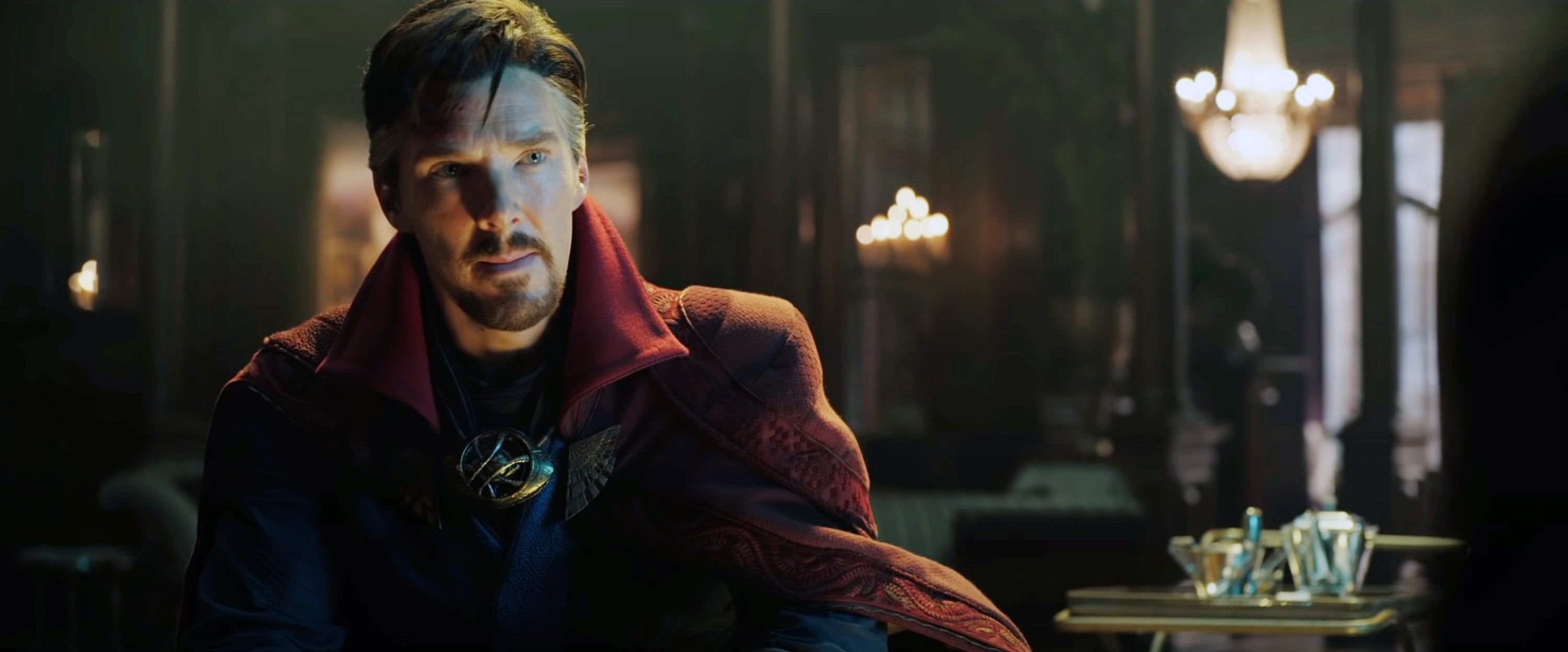 Doctor Strange in a dimly lit room with chandeliers