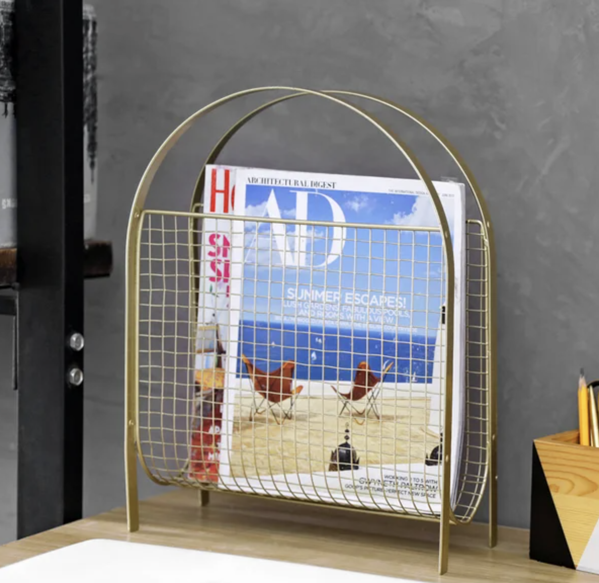 A magazine rack on a table with magazines placed inside of it