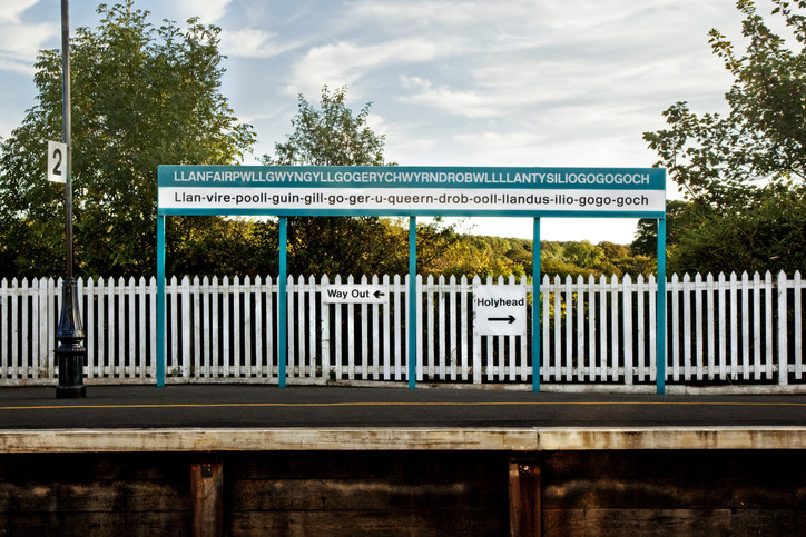 a sign along a fence with the town name