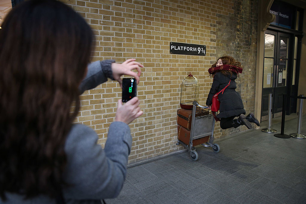 tourists taking a photo at the platform