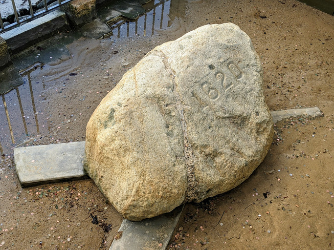 a large rock with the year 1620 engraved