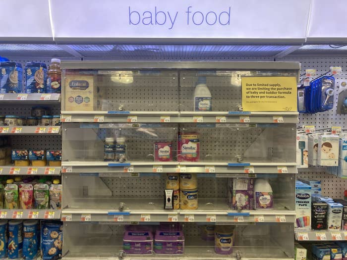 A security case in a pharmacy with a sign that reads &quot;Due to limited supply, we are limiting the purchase of baby and toddler formula to three per transaction&quot;