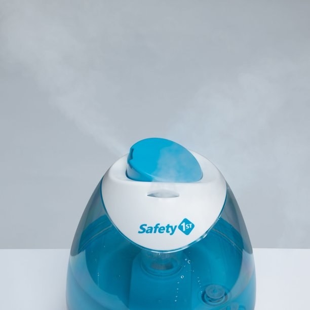 Blue humidifier with steam coming out