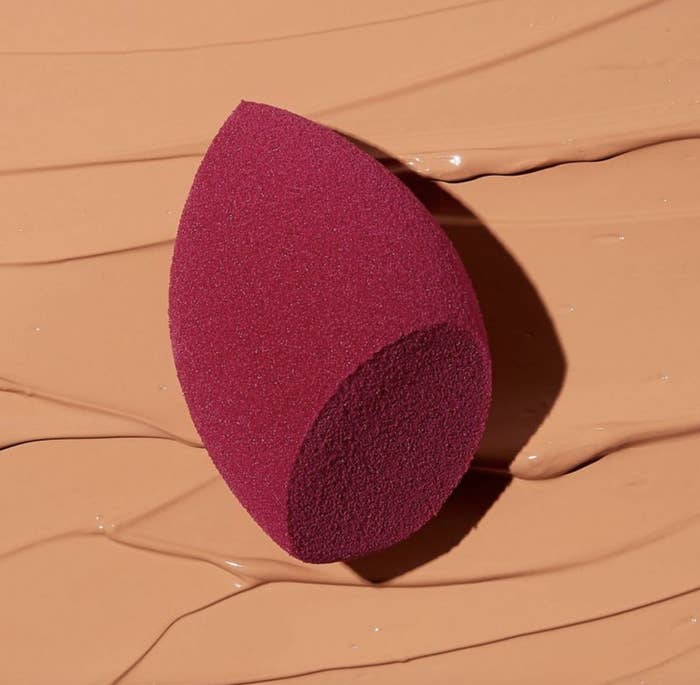 A makeup sponge on top of liquid makeup