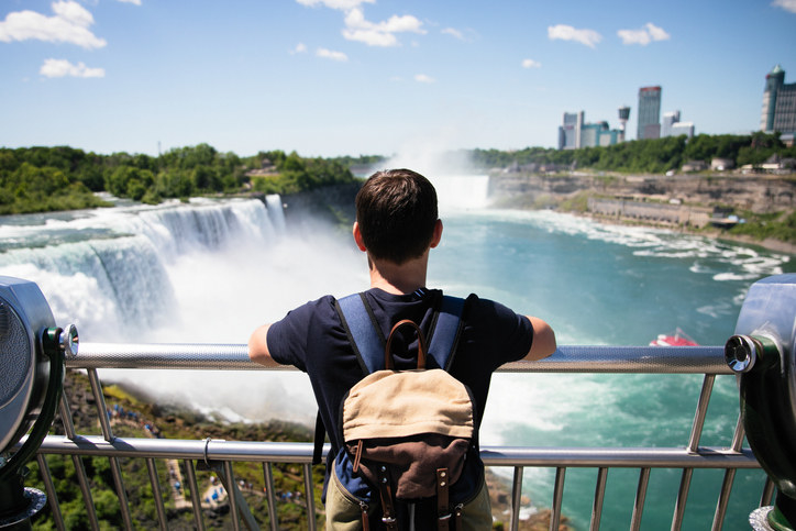 someone looking out at the waterfall