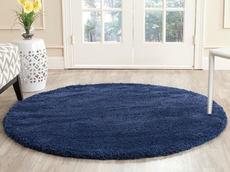 a round navy rug in a living room
