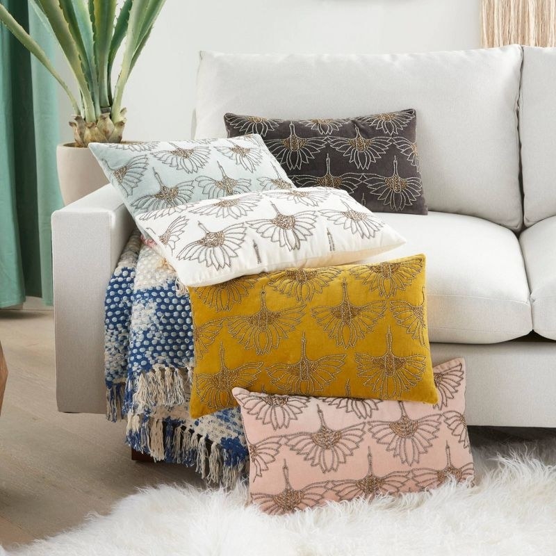 beaded throw pillows in multiple colors on a couch