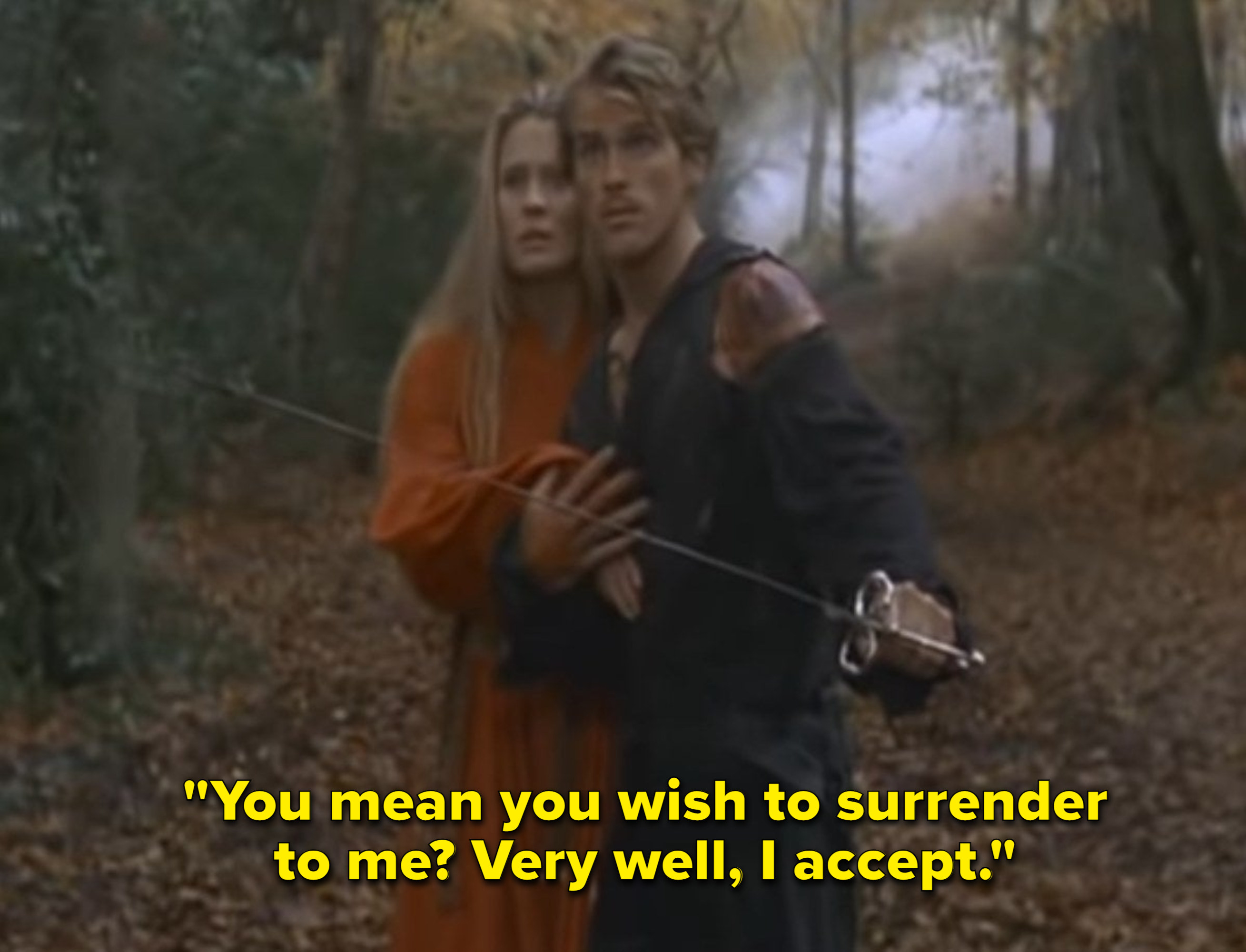 Buttercup stands behind Westley in a forrest