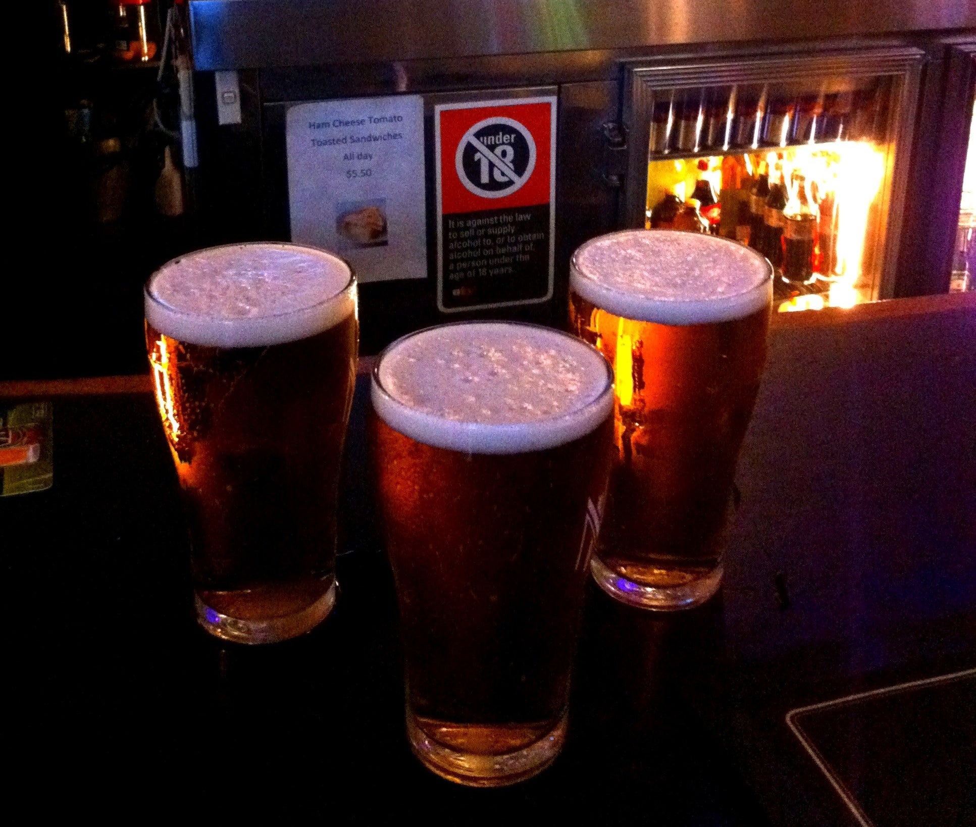 Three glasses of beer on the bar in a pub, Bondi Junction, Sydney, NSW, Australia