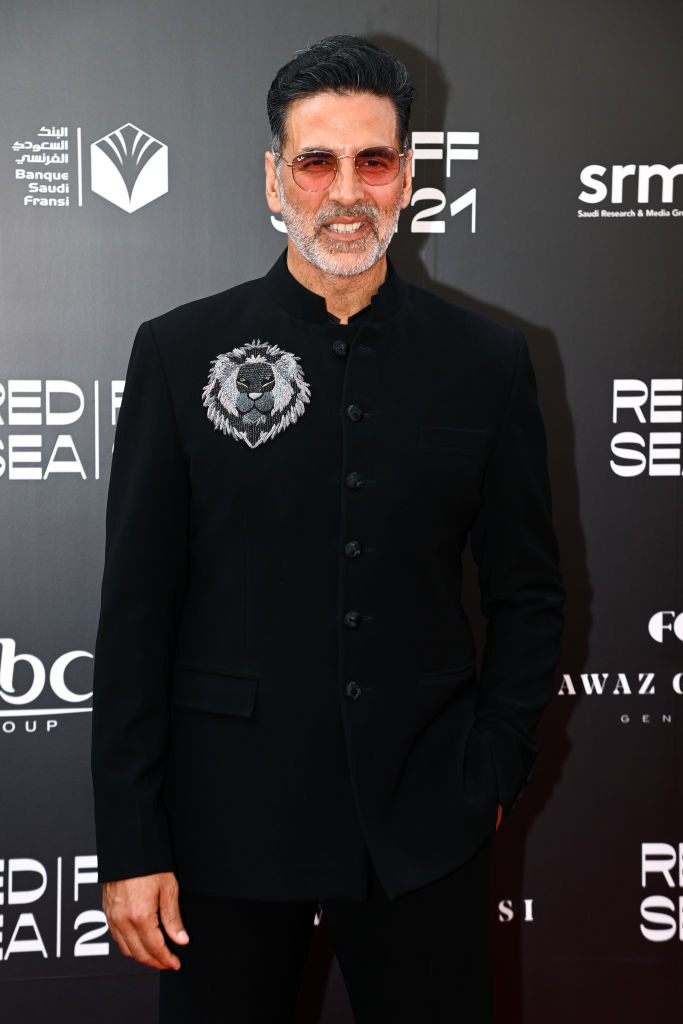 Akshay Kumar, wearing sunglasses and a black suit poses for a photograph