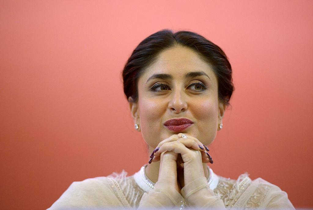 Kareena Kapoor smiles and sits with her hands folded underneath her chin