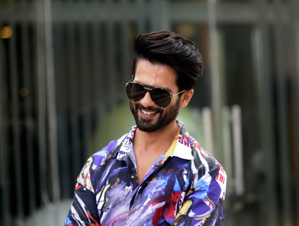 Shahid Kapoor, wearing sunglasses and a printed shirt, smiles for a photograph