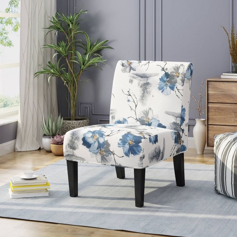 An image of a floral accent chair with sturdy wood construction, rubber wooden legs,  and plush cushion seating