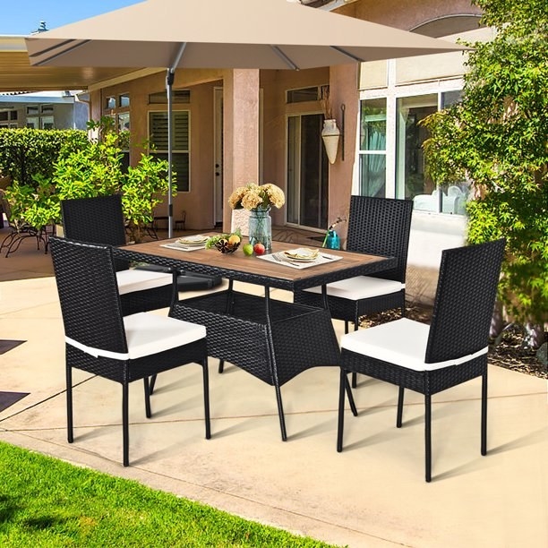The five piece rattan set outside on a patio