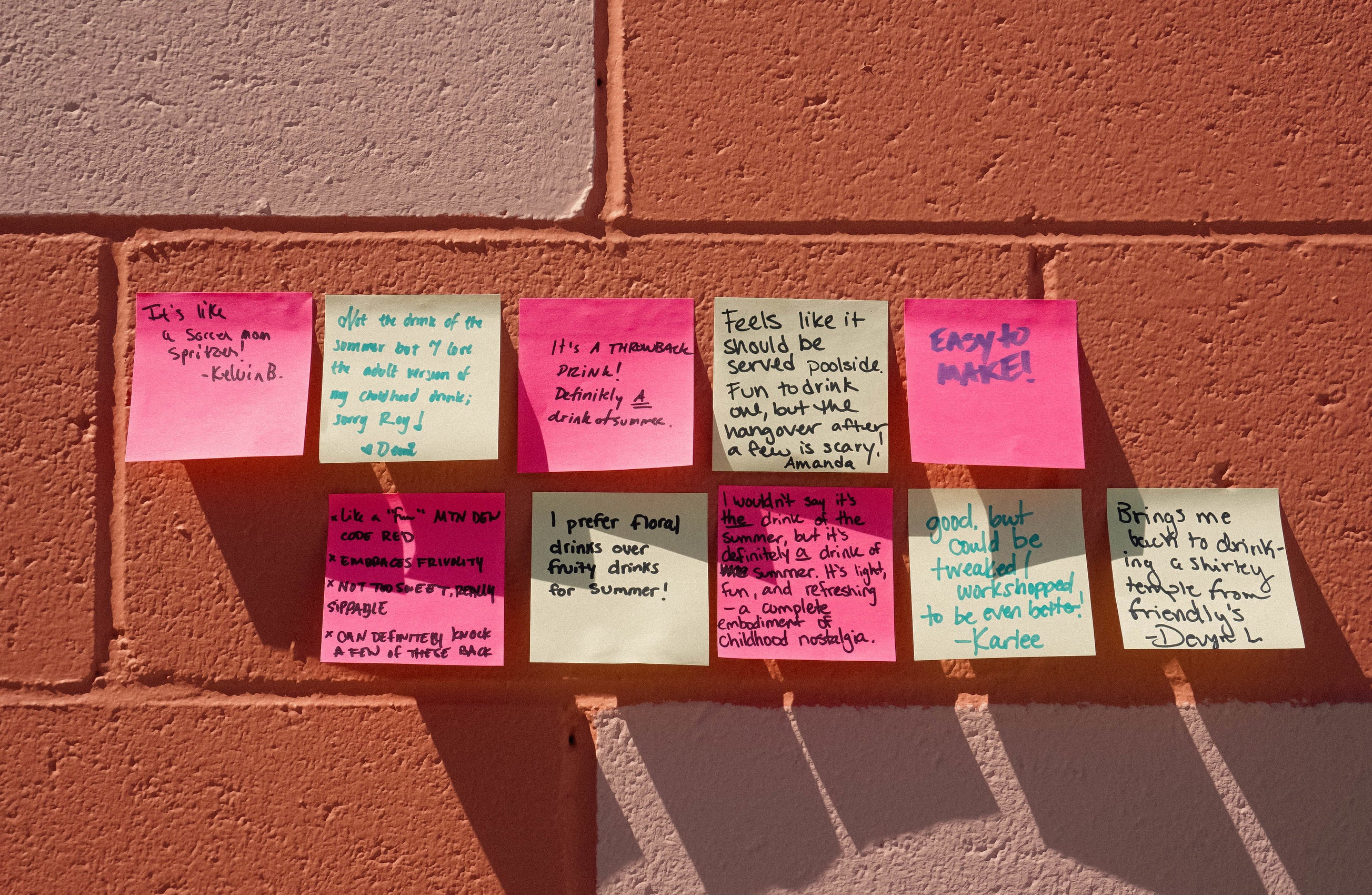 Colored Post-It notes with feedback; five notes are pink for yes, five yellow for no