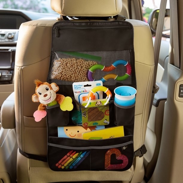 The organizer on the back of a carseat filled with kid stuff
