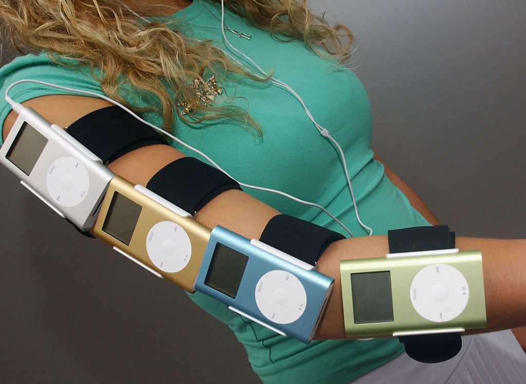 A person with four iPods in a row strapped to their arm