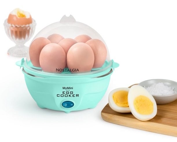 the turquoise egg cooker next to sliced eggs on a cutting board