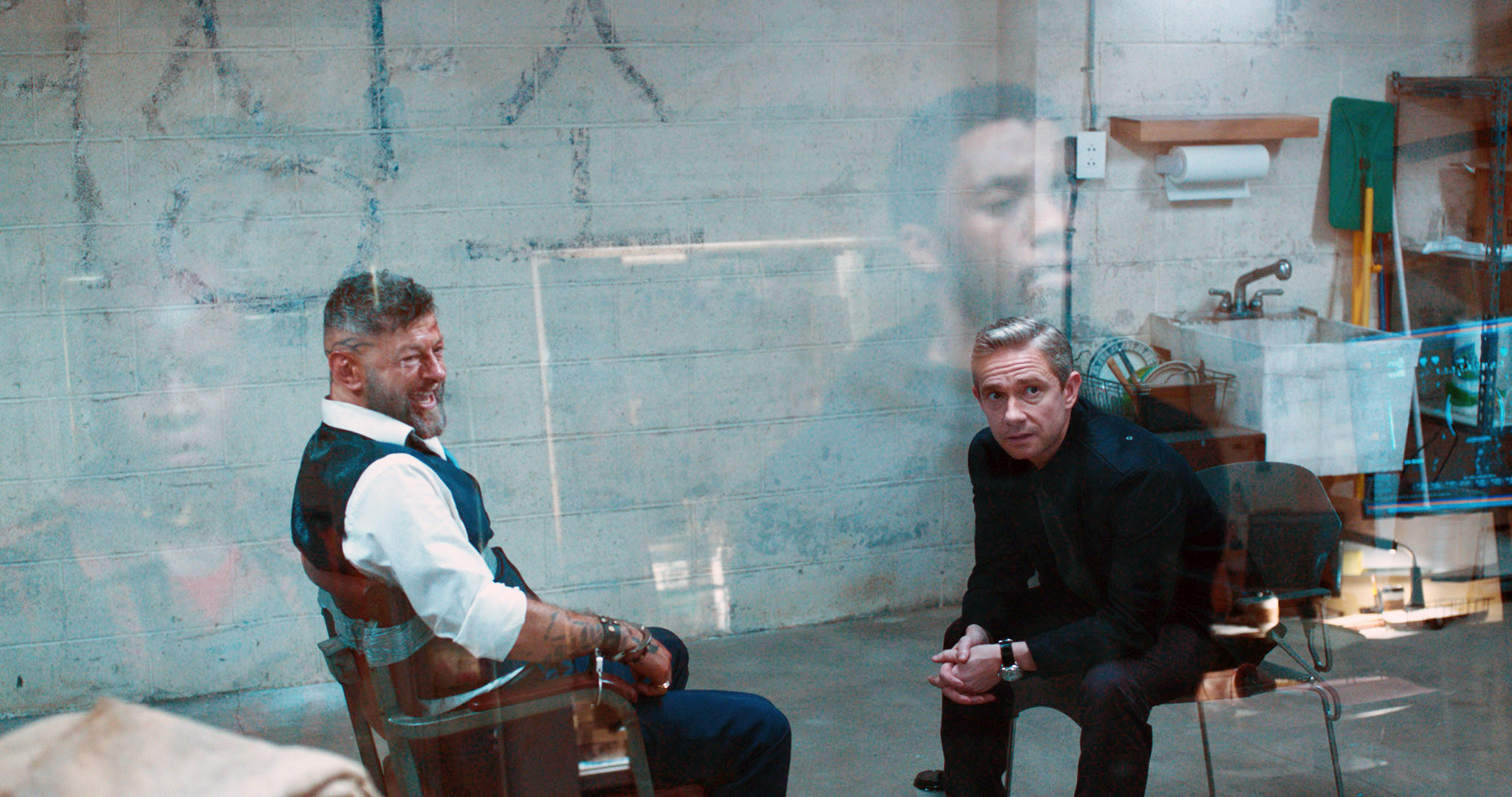 Martin&#x27;s character in the film sits in an interrogation room while Chadwick&#x27;s character looks in