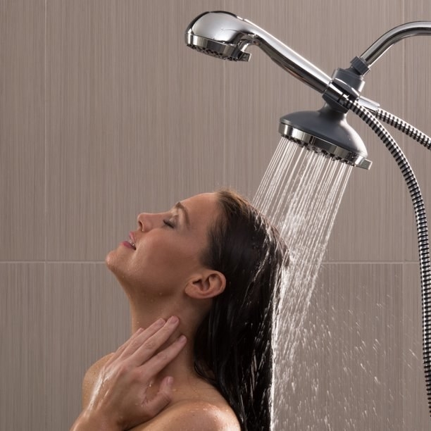 A person showers using the double shower head