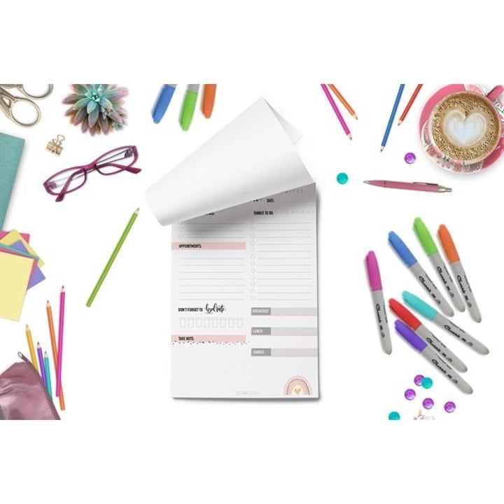 The notepad surrounded by office supplies