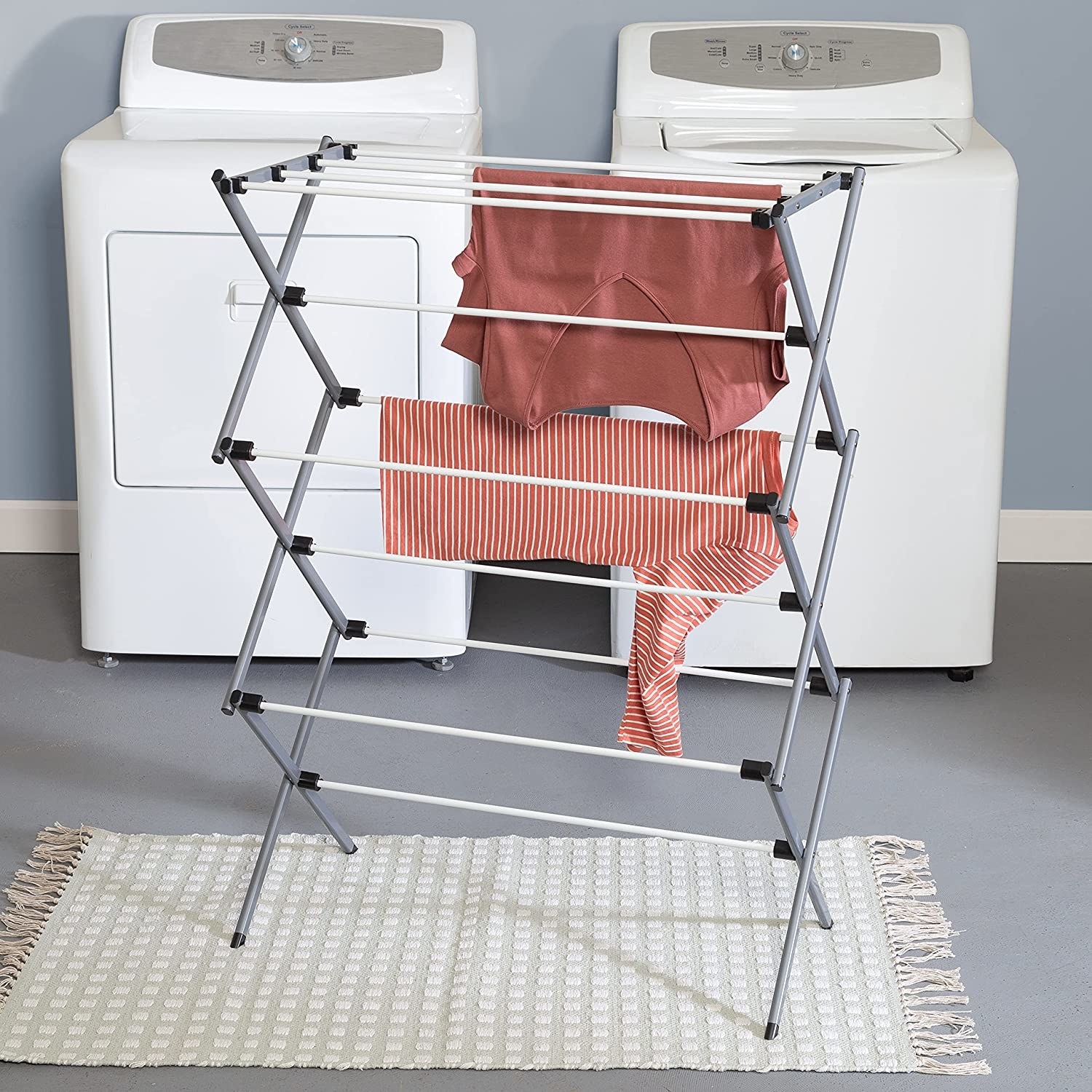 the folding drying rack next to washing machine and dryer