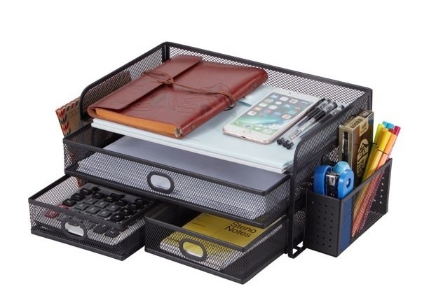 the black mesh organizer filled with supplies like calculator notebook pens stapler and phone