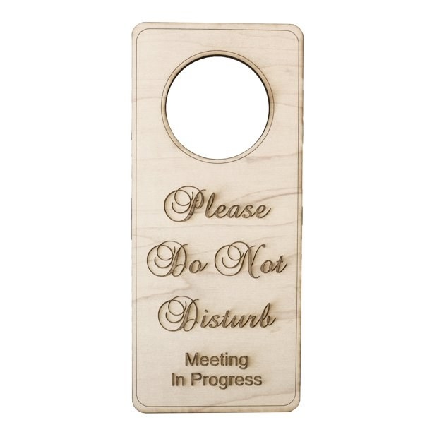 The hanging doorknob sign reading &quot;please do not disturb meeting in progress&quot;