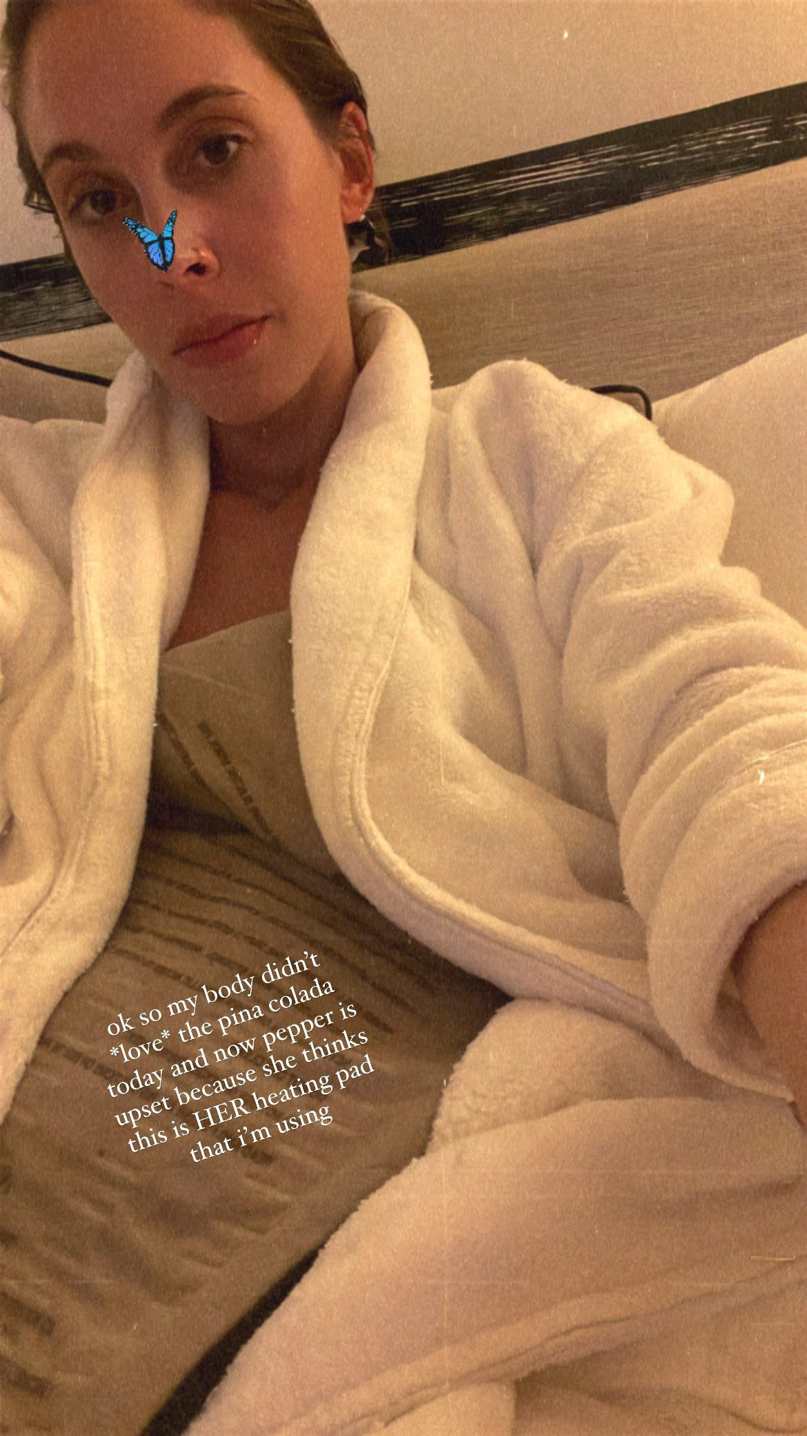 Selfie of the author in bed with the hotel robe