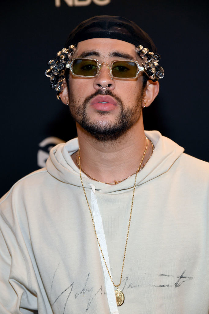 Bad Bunny wearing a beret and sunglasses that look like they have marbles glued to them