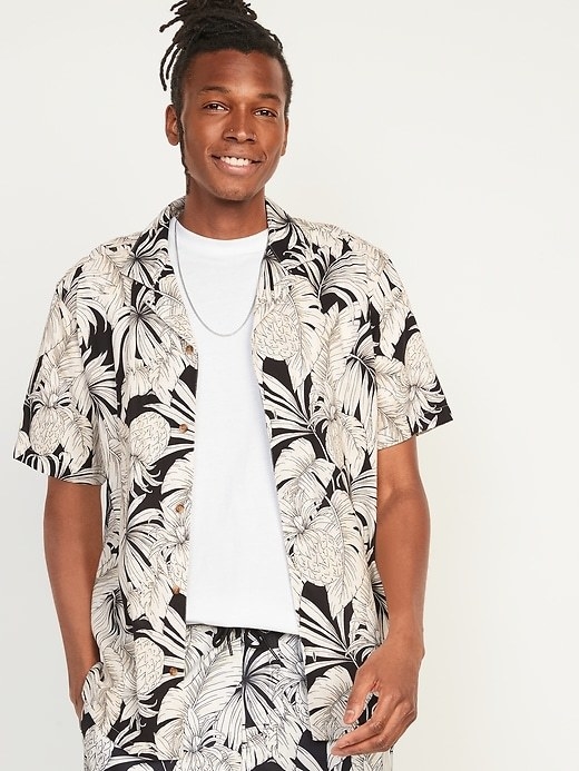 a model wearing the black and white printed shirt with matching shorts