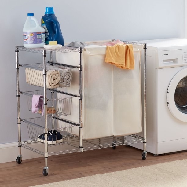 The laundry hamper and storage cart next to a washer and dryer