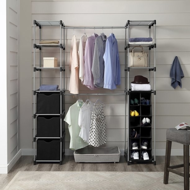 The closet system set up with clothes and accessories on it