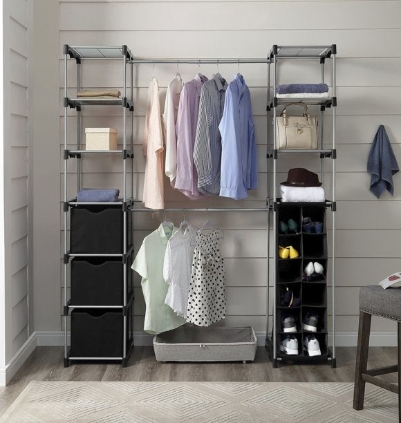 Modular closet organizer filled with various clothes, shoes, and storage boxes