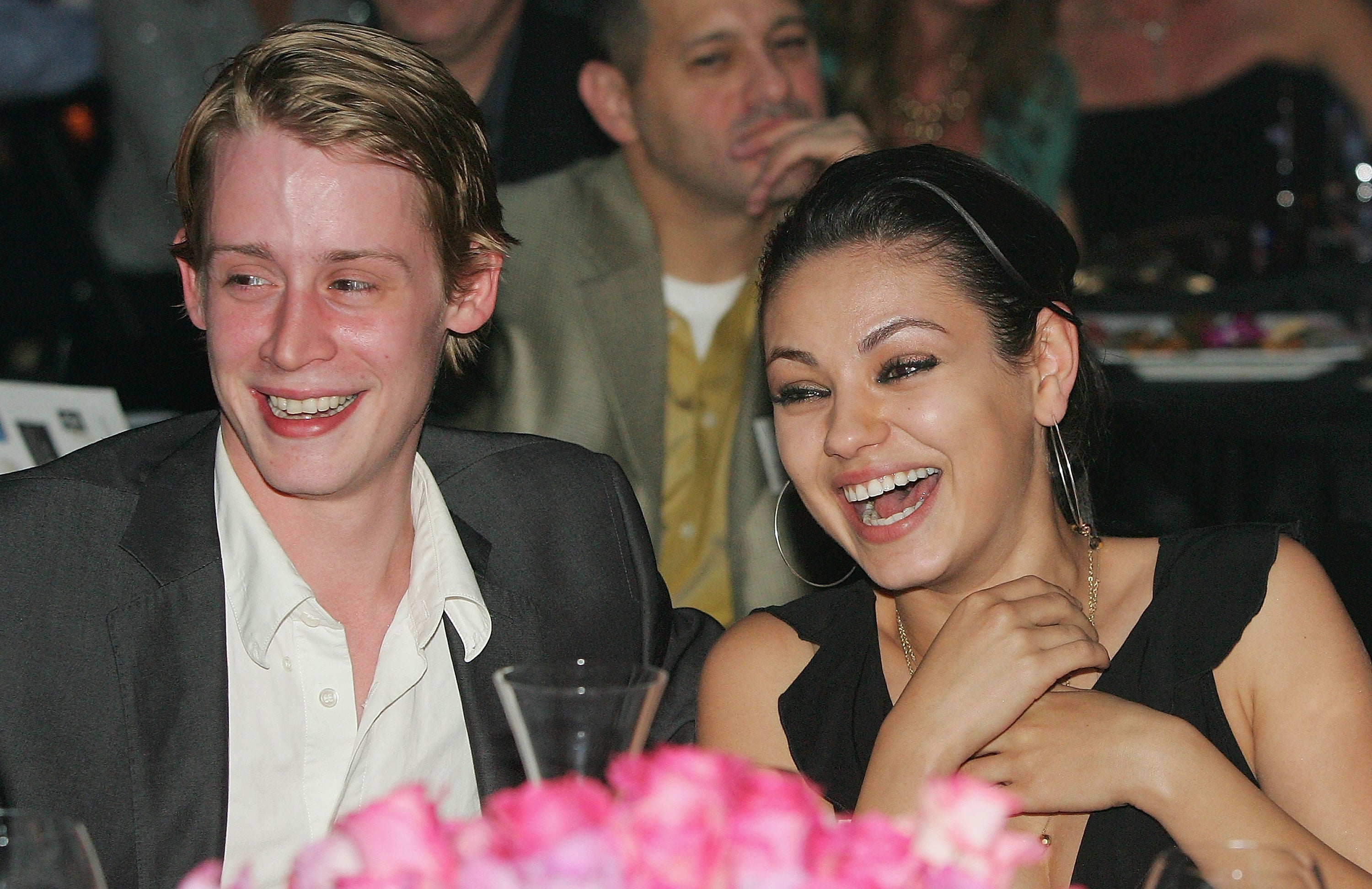 Macaulay Culkin and Mila Kunis smiling at the launch of the &quot;uBid for Hurricane Relief&quot; charity auction and benefit at the Empire Ballroom