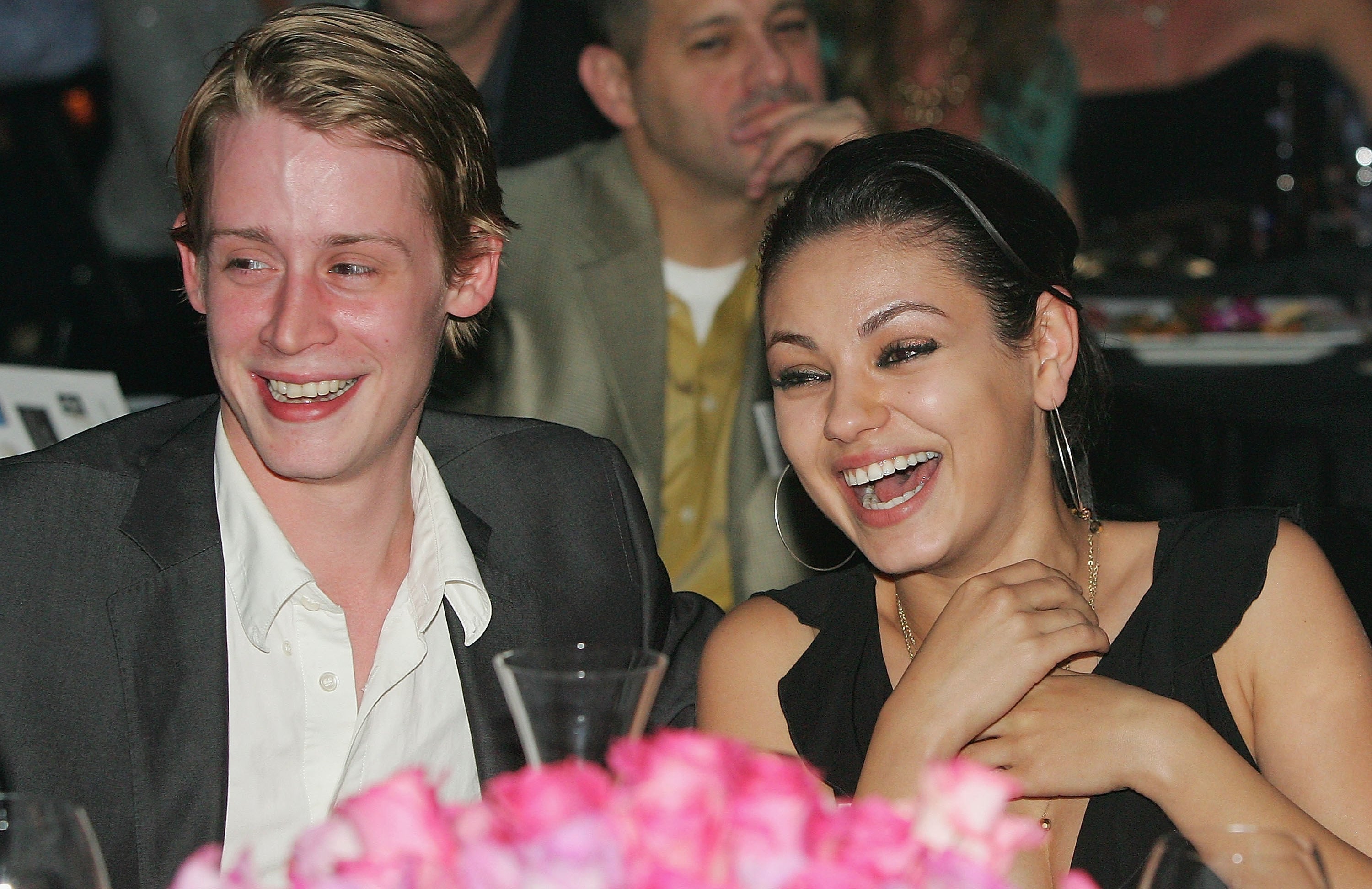 Macaulay Culkin and Mila Kunis smiling at the launch of the "uBid for Hurricane Relief" charity auction and benefit at the Empire Ballroom