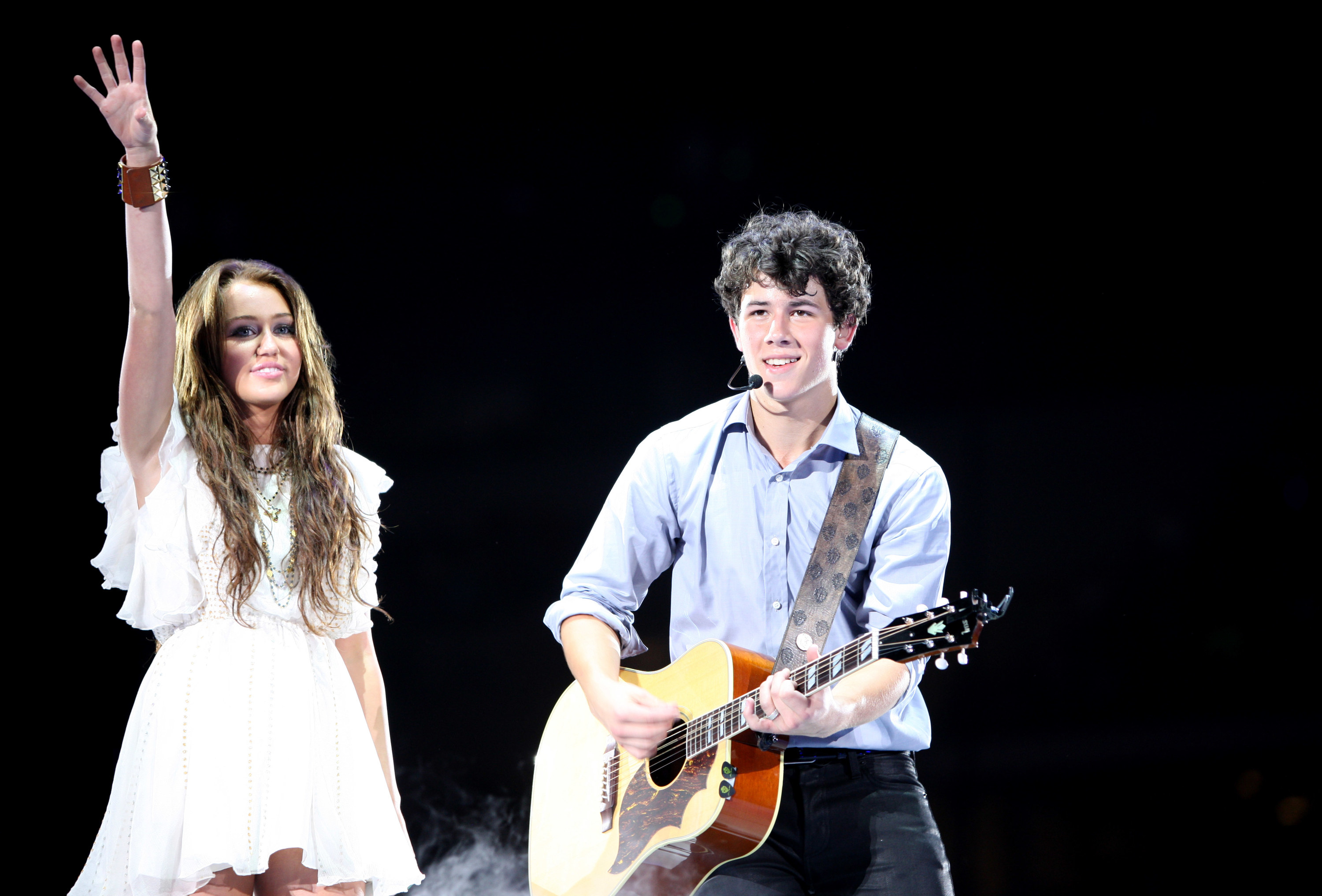 Miley Cyrus and Nick Jonas of Jonas Brothers perform at New Cowboys Stadium