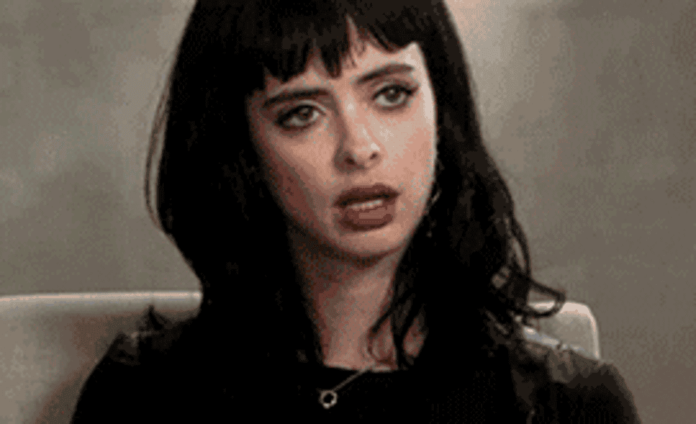 Krysten Ritter rolling her eyes and putting her head down.