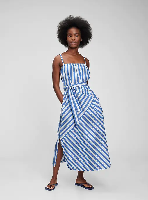 A person wearing a maxi dress with a bold striped pattern