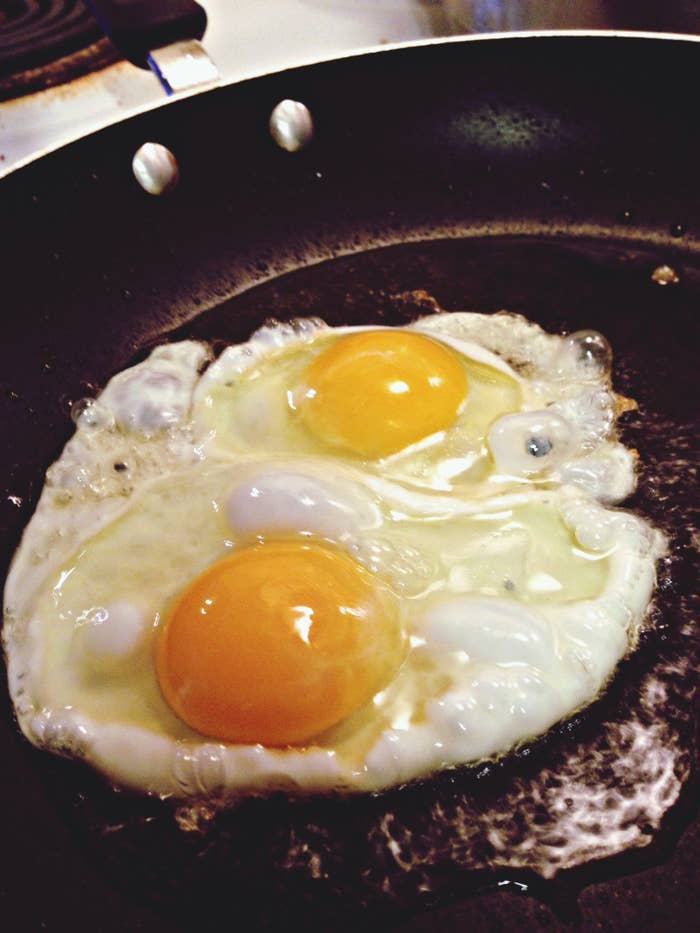 Close-up of fried eggs cooking in a pan