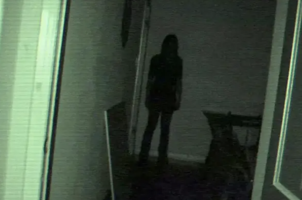A shadowy figure at the end of a hallway.